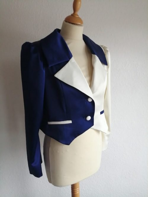 Navy blue and white blazer with puffed sleeves on a white mannequin